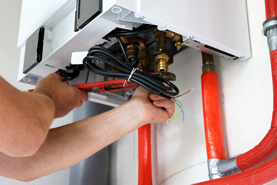technician-repairing-heating-system-at-house-montgomery-mn